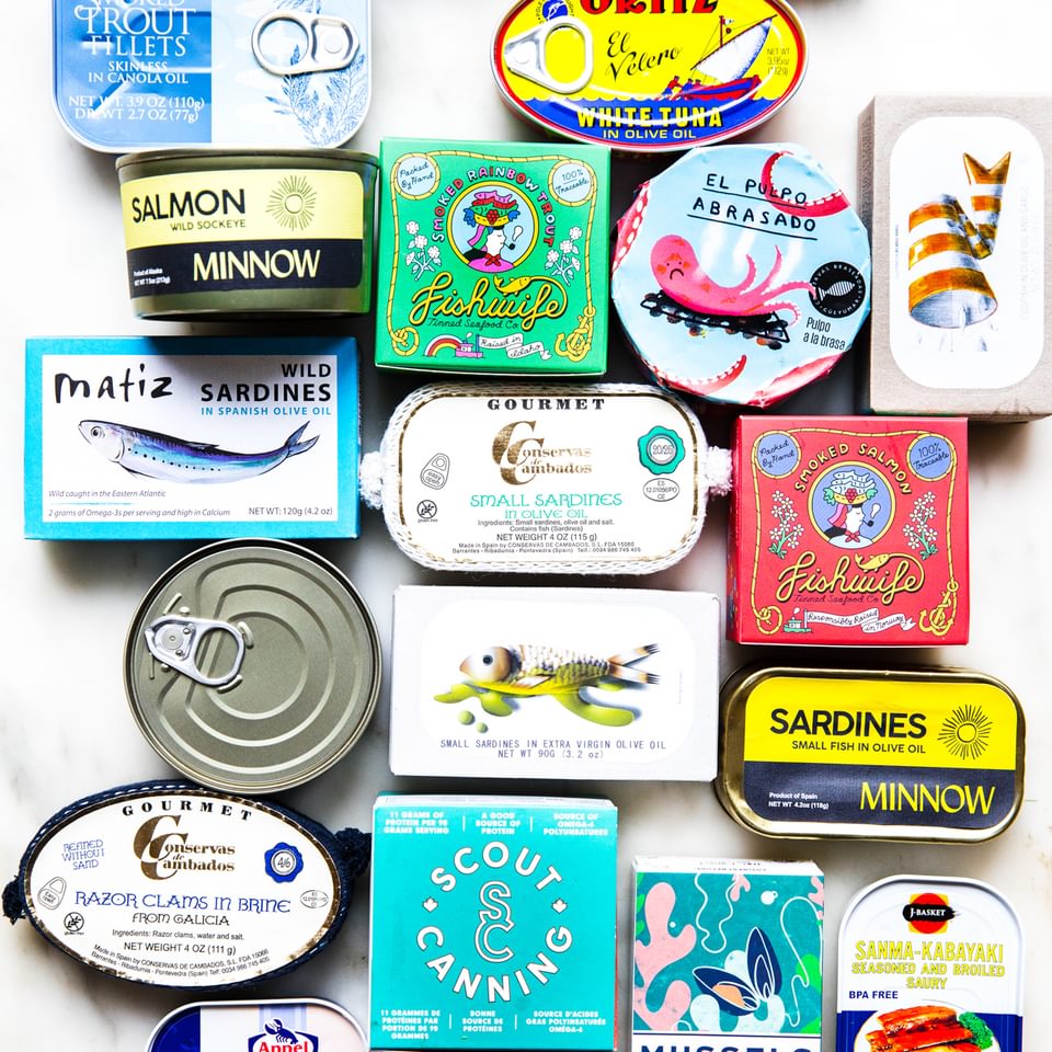 White background with various tin fish packages lined up