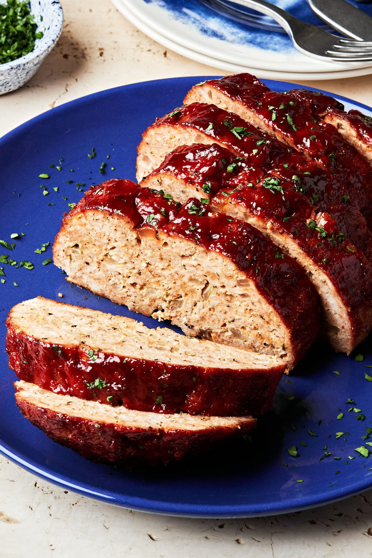 homemade turkey meatloaf with a brown sugar sauce sliced on a serving plate
