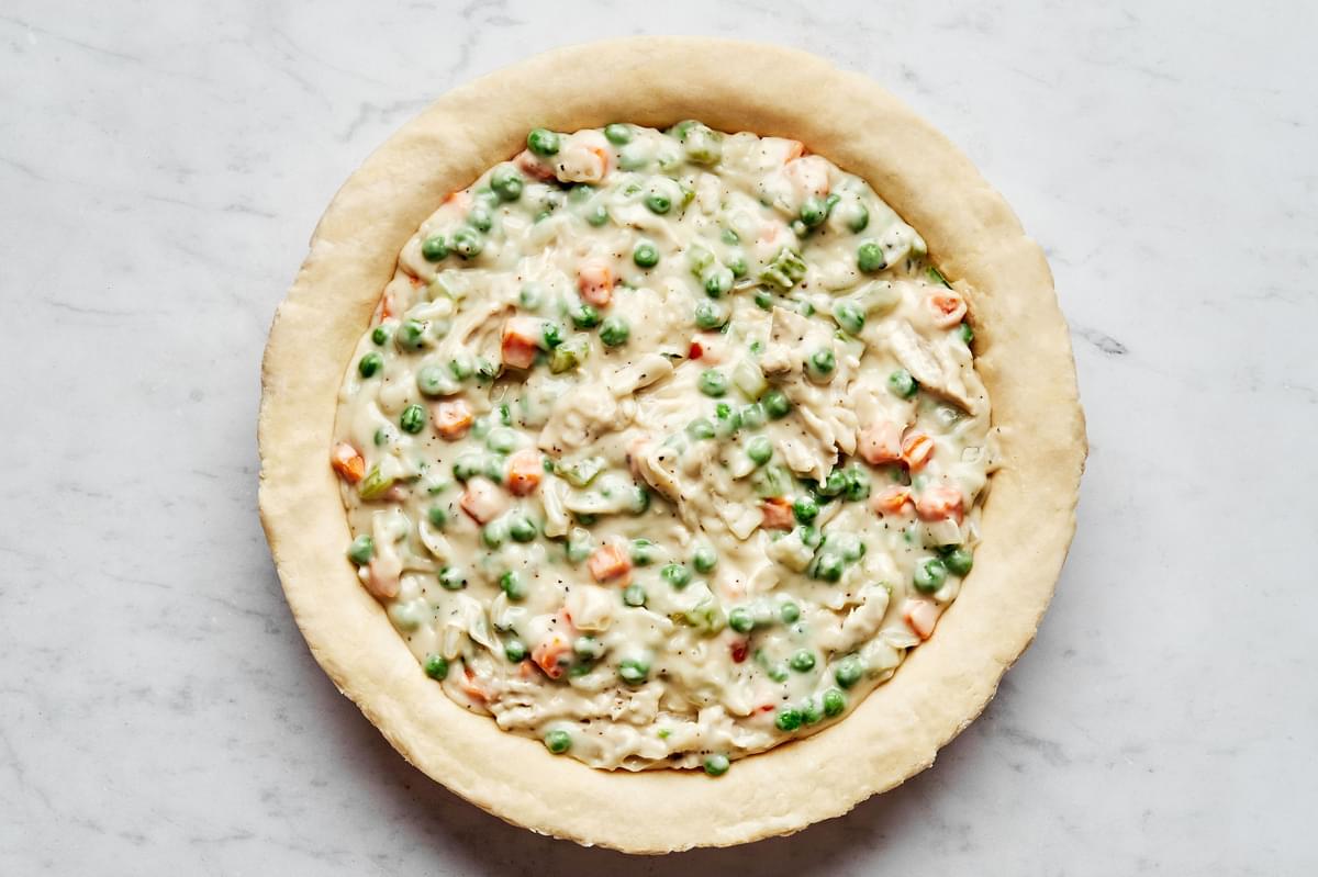 pie crust filled with turkey pot pie filling made with turkey, peas, celery, carrots, onion, thyme, salt & pepper