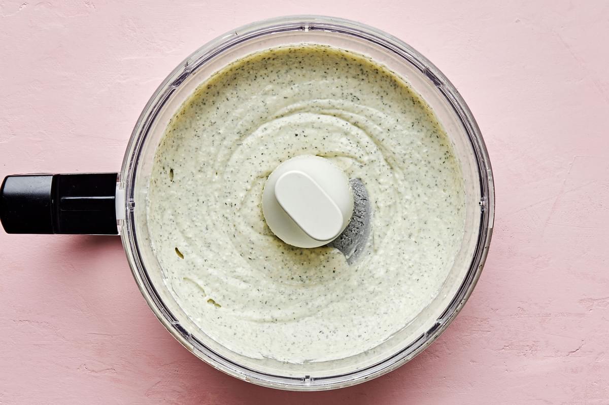 homemade whipped feta dip in a food processor made with feta, olive oil, greek yogurt, lemon juice, milk and spices