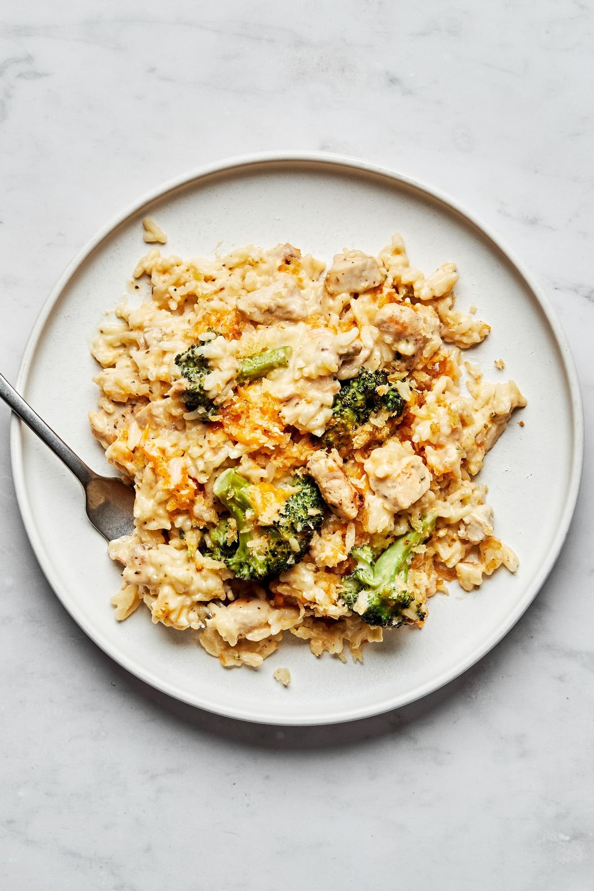 Chicken Broccoli and Rice Casserole topped with toasted panko breadcrumbs on a plate with a fork