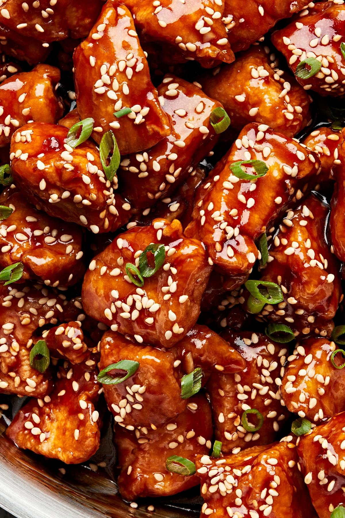 homemade sesame chicken sprinkled with sesame seeds and green onions