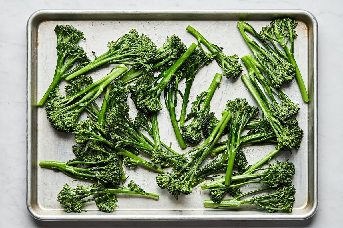 broccolini tossed with olive oil and salt on a baking sheet