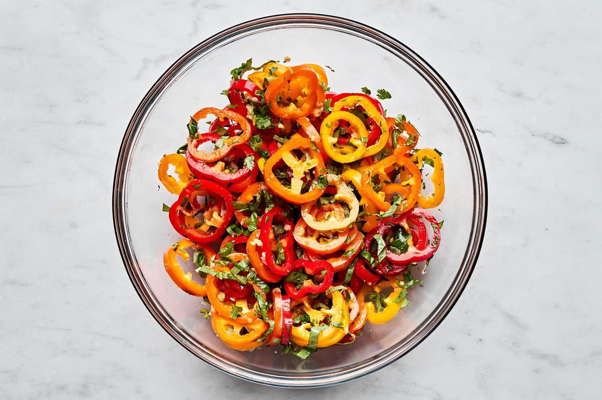 pepper salad in a bowl made with peppers, cilantro, basil, garlic, ginger, sesame oil, lime juice and salt