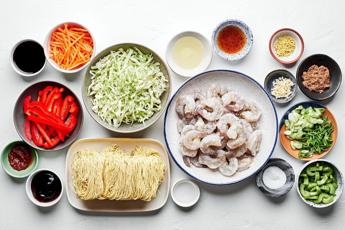 shrimp, chow mein noodles, soy sauce, chili sauce, ginger, garlic, sesame oil and shredded vegetables in prep bowls