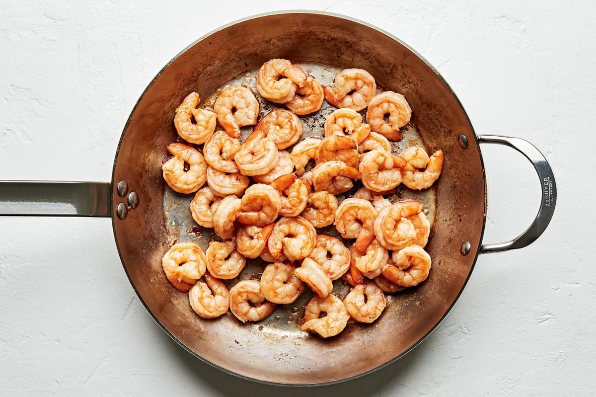 marinated shrimp cooked in a skillet with vegetable oil and sesame oil