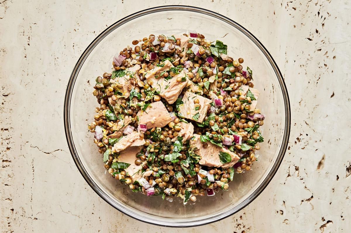 tuna lentil salad in a bowl made with lentils, tuna, red onion, capers fresh herbs and homemade dressing