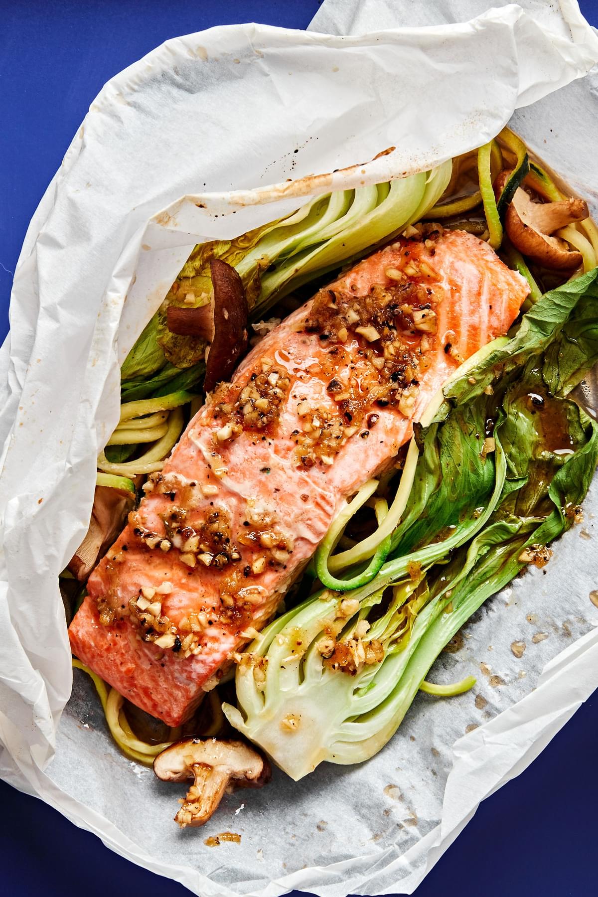 30 Minute garlic ginger salmon dinner with zucchini noodles, bok choy and shitake mushrooms in parchment paper