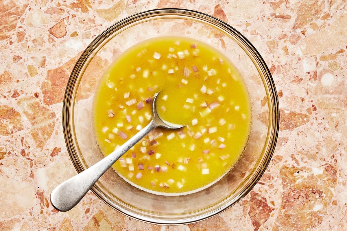 shallots, olive oil, lemon juice, mustard, sugar, and salt mixed together in a bowl