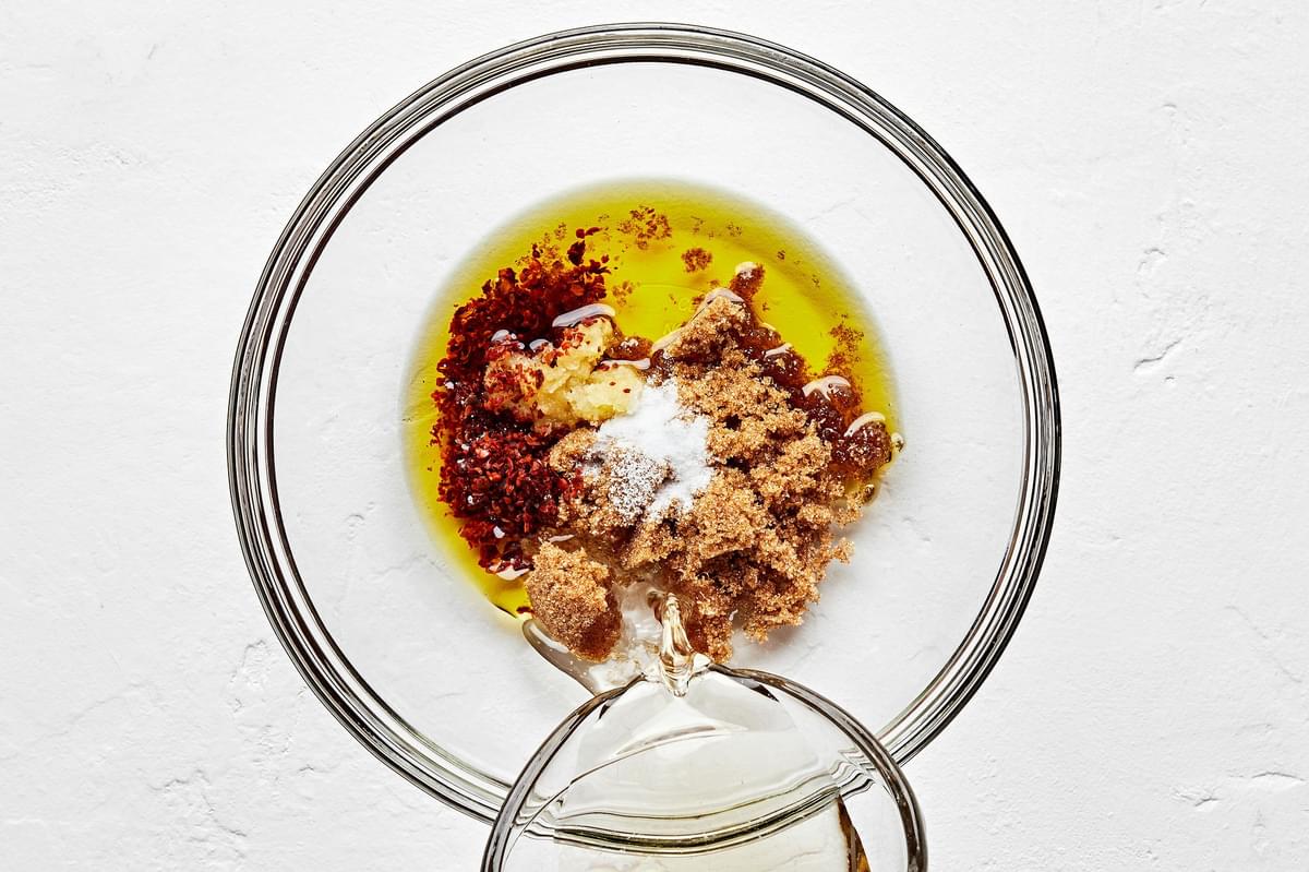 vinegar, garlic, brown sugar, olive oil, pepper, and salt in a glass bowl