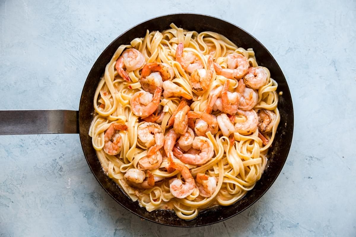 bang bang shrimp pasta in a pan with creamy pasta sauce