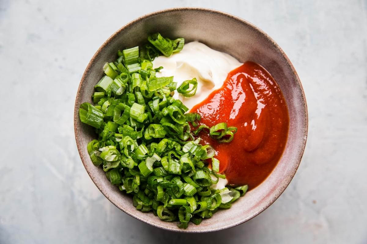 mayonnaise sriracha and green onions in a bowl