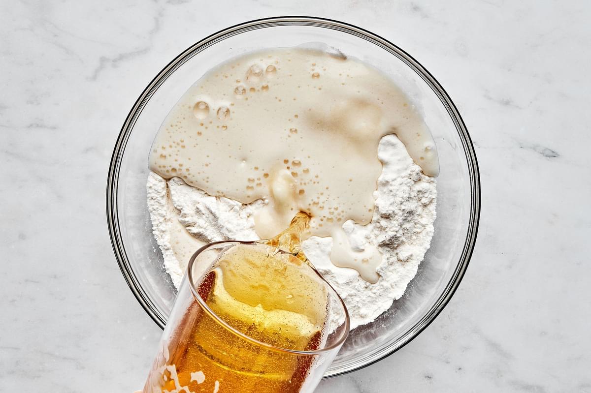 baking powder, flour, salt and beer being combined in a bowl