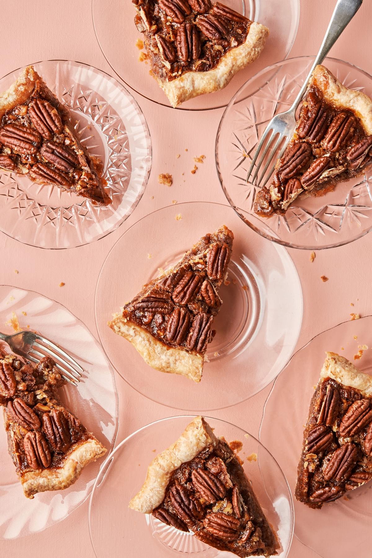 a slices of bourbon pecan pie made with brown sugar, corn syrup, cinnamon, butter and vanilla on dessert plates