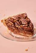 a slice of homemade bourbon pecan pie made with brown sugar, corn syrup, cinnamon, butter and vanilla
