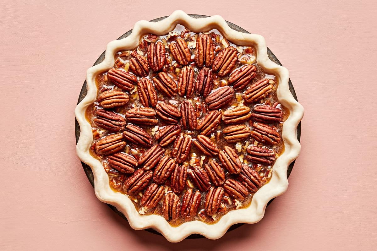 a homemade bourbon pecan pie ready to be baked in the oven