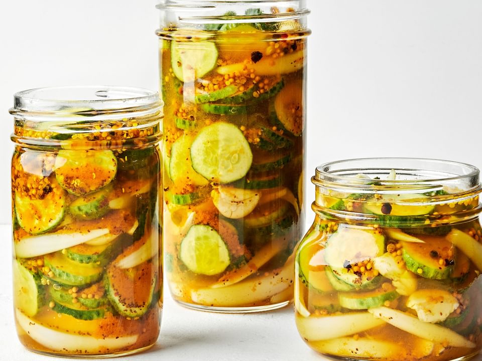 3 glass jars filled with homemade bread and butter pickles