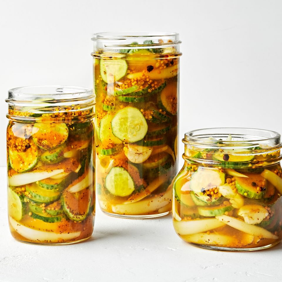 3 glass jars filled with homemade bread and butter pickles