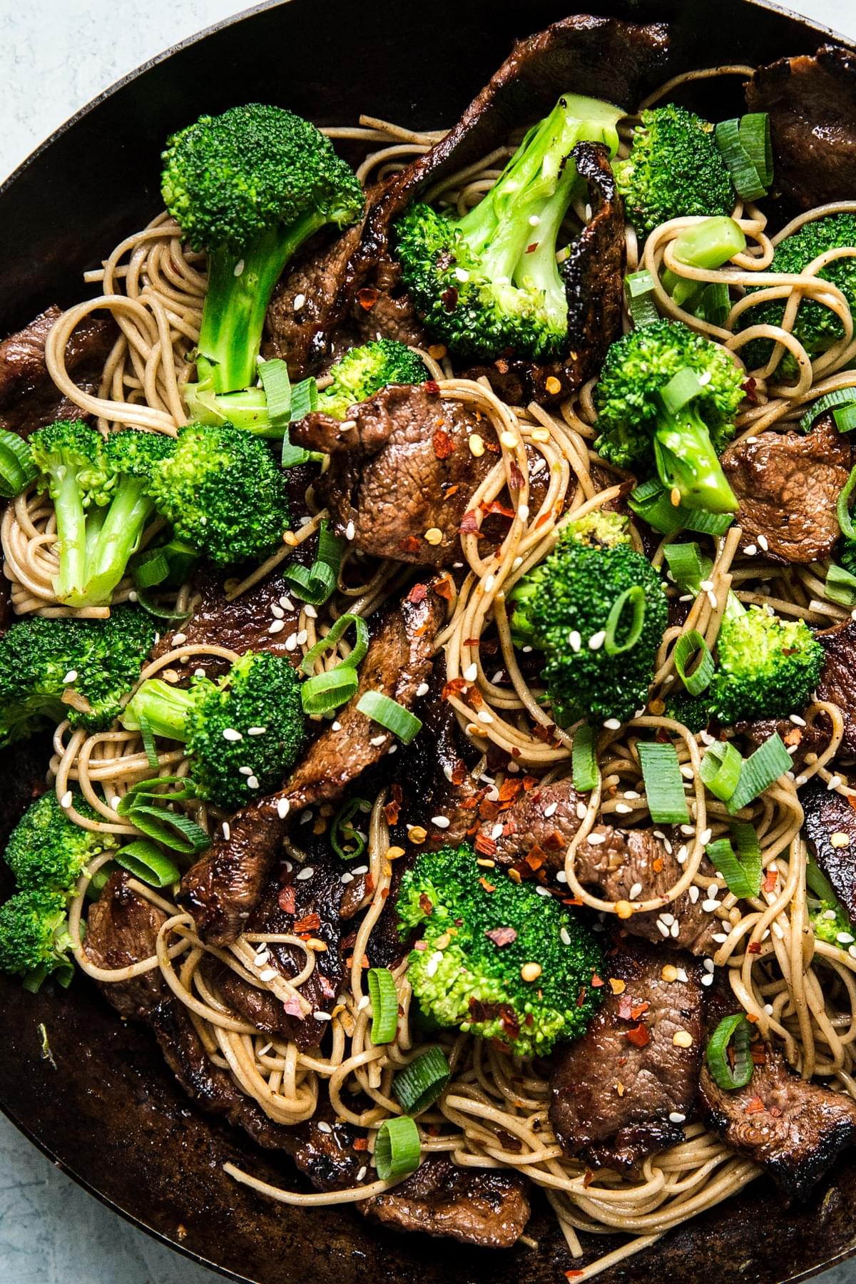 Broccoli beef soba noodles in a sauce pan