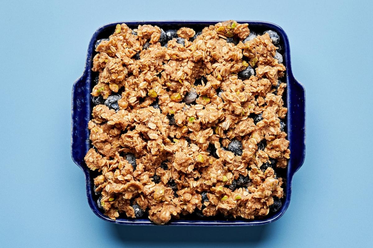 Brown Butter Blueberry Crumble with Pistachios in a baking dish