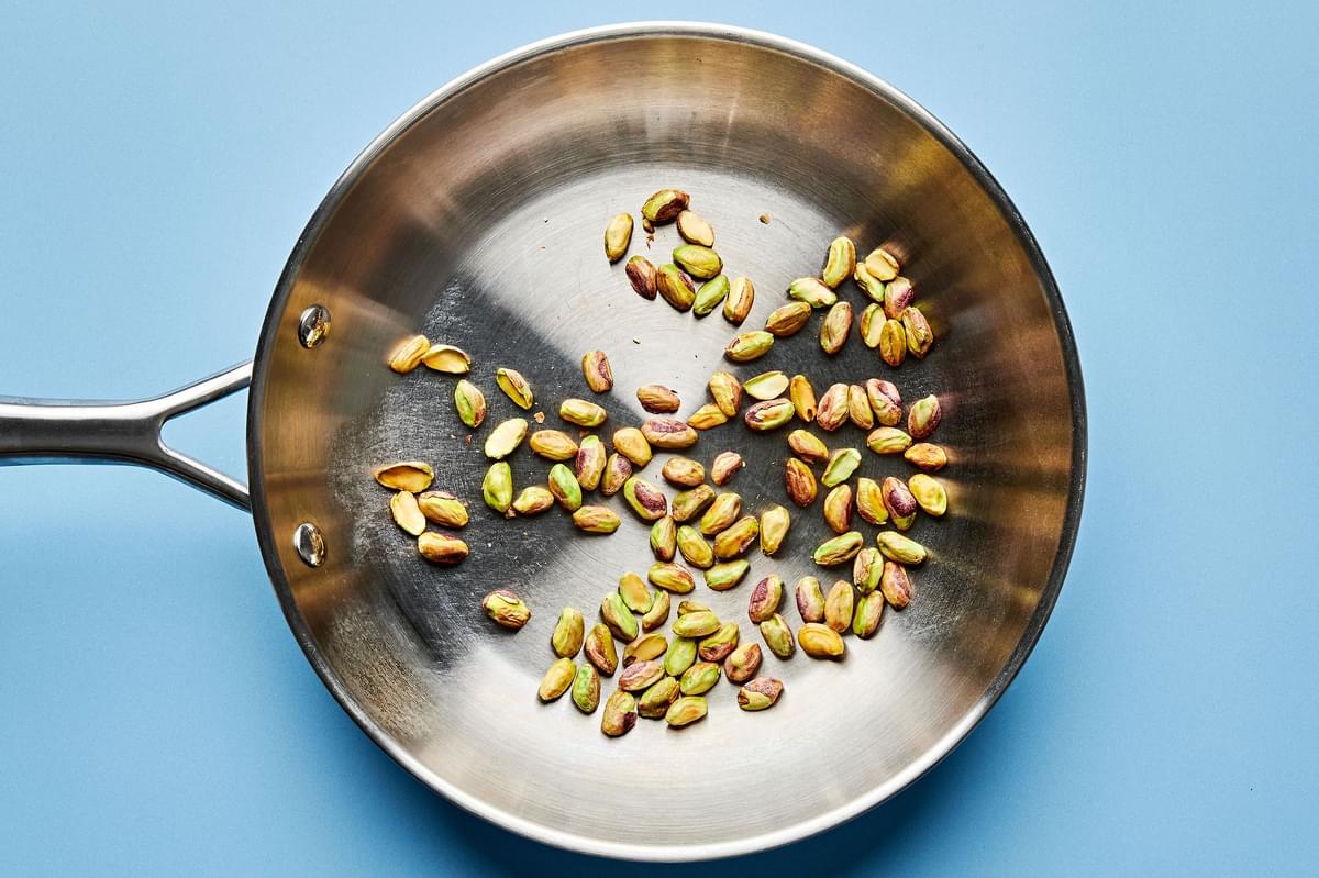 pistachios being toasted in a skillet