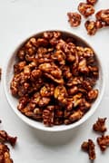 a bowl of homemade candied walnuts made with brown sugar, butter, salt and cayenne