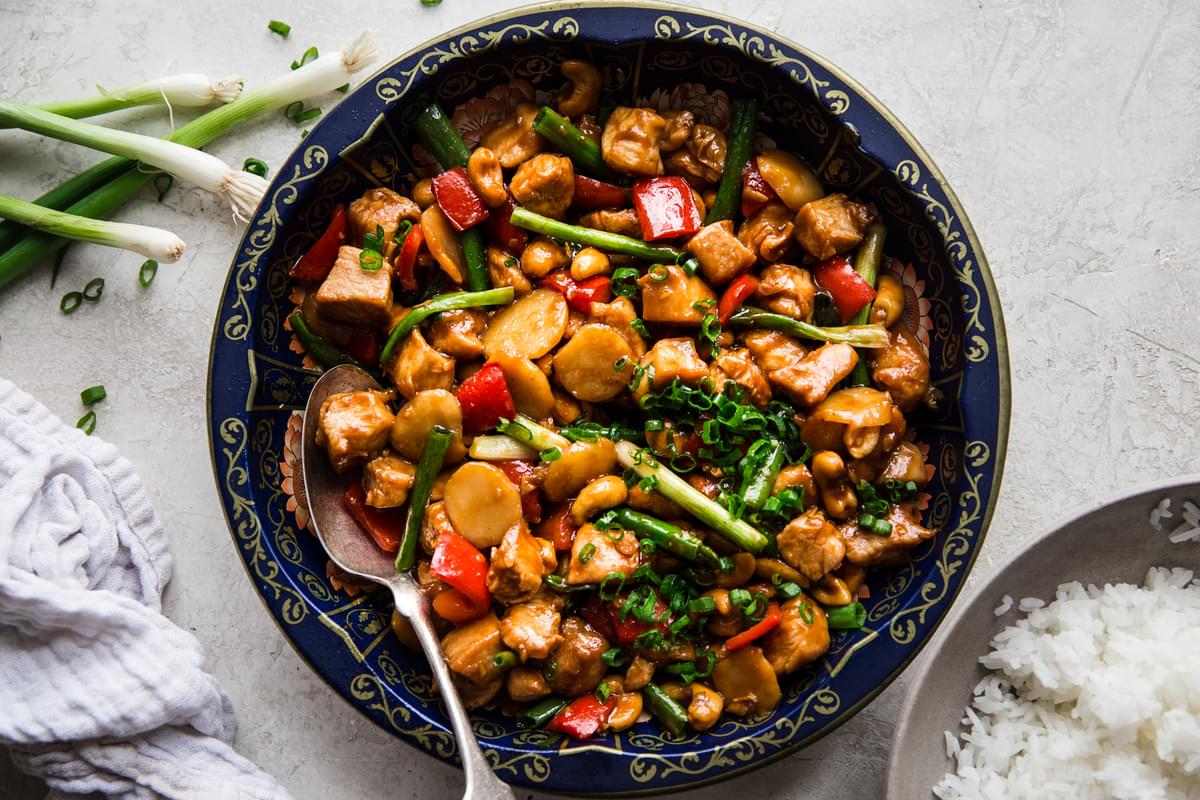 Chinese cashew chicken recipe homemade in a serving bowl with a serving spoon
