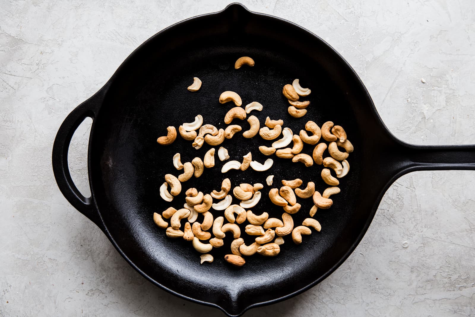 raw unsalted cashews toasted in a skillet