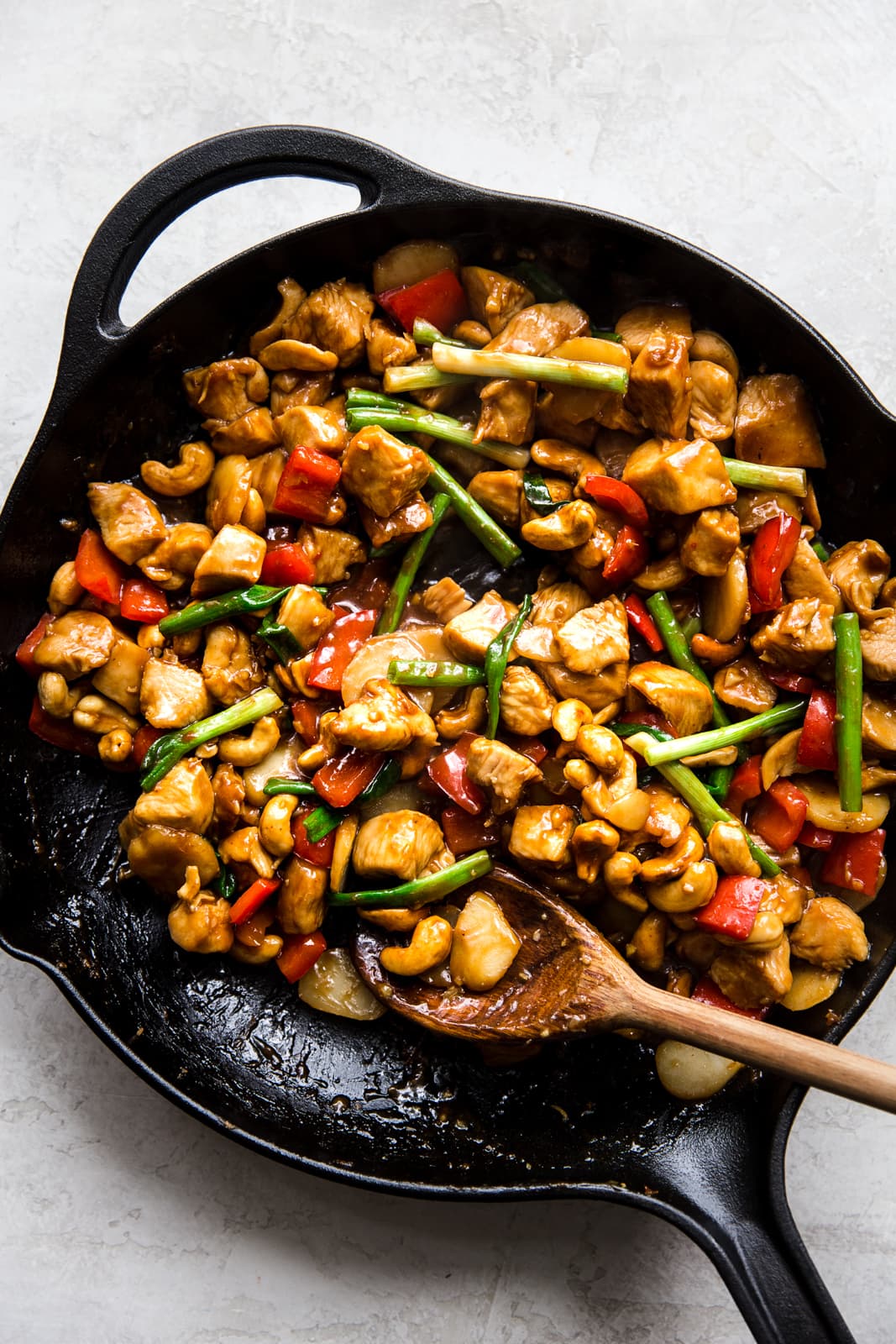 chicken with cashew nuts in a saucepan with soy sauce and ginger and garlic.