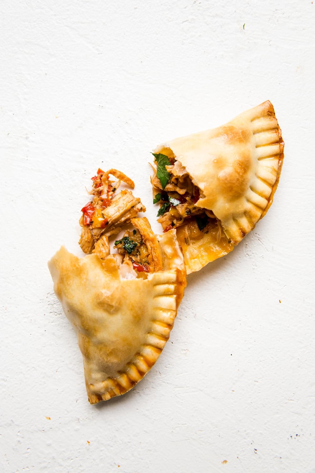a chicken empanada cut in half to reveal the filling