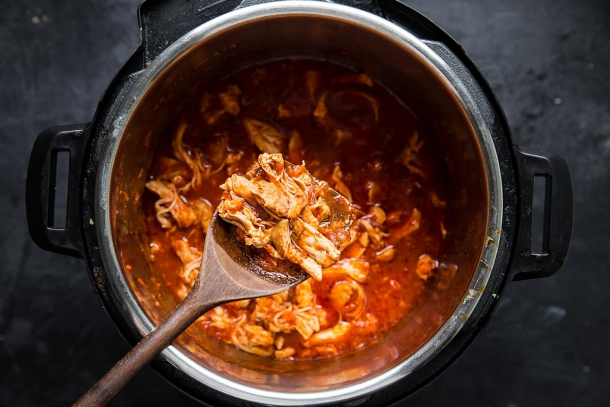 shredded chicken thigh meat cooked in marinara sauce in an instant pot.