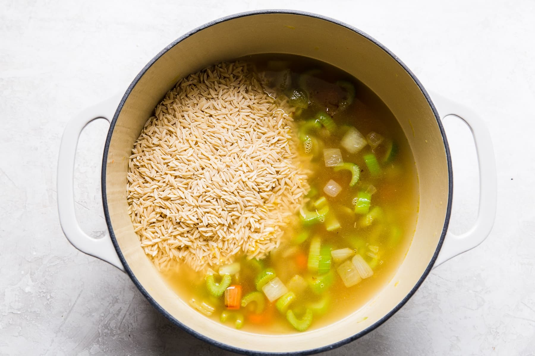 carrots, onion, celery, chicken stock and orzo in a soup pot