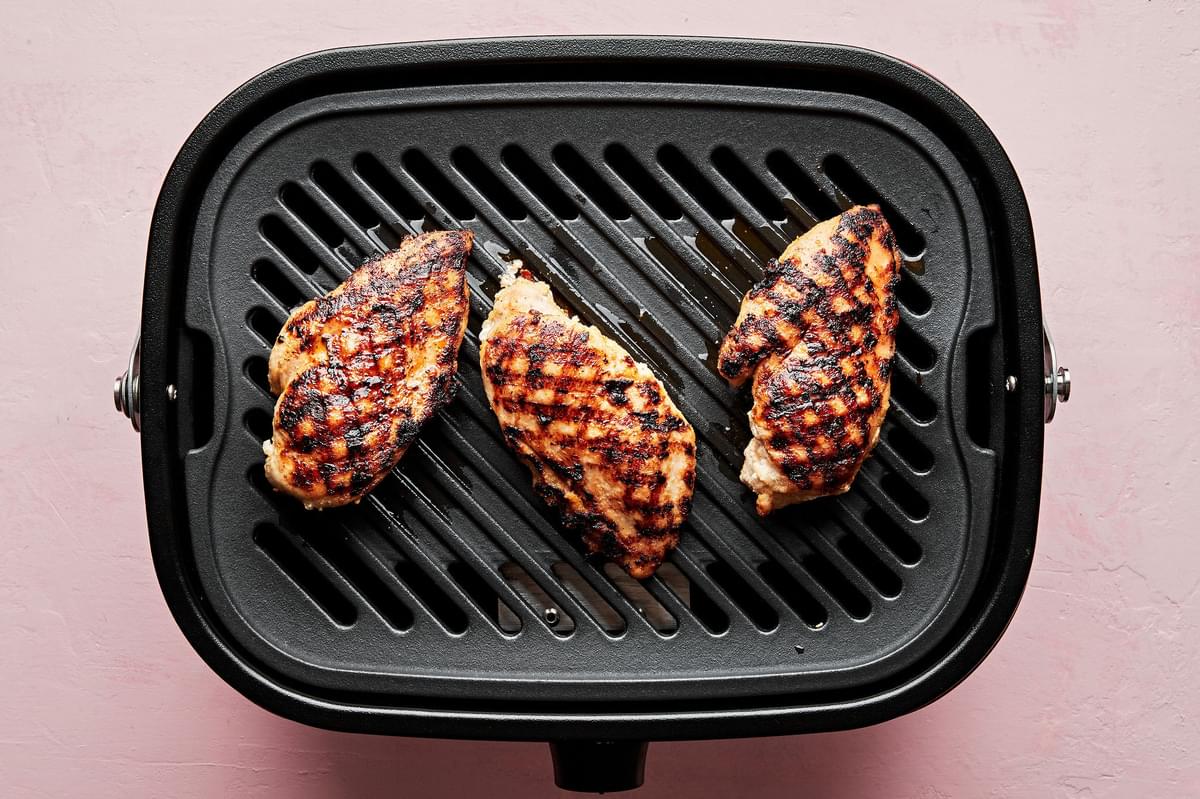 chicken seasoned with salt, garlic powder, and onion powder cooking on a grill