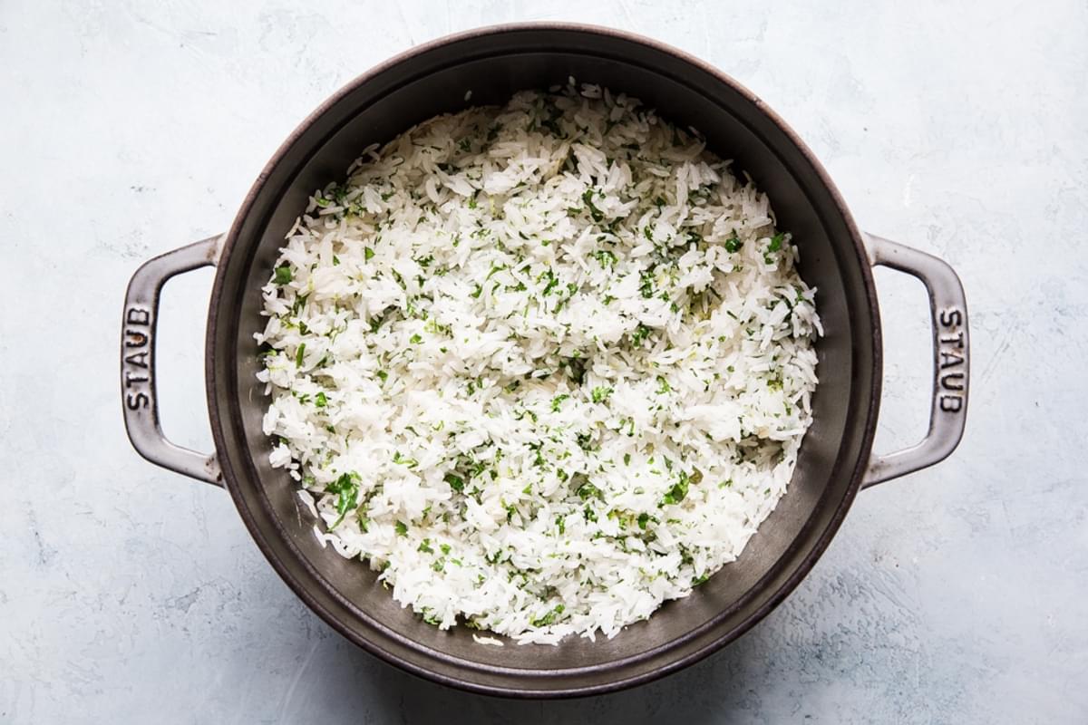 cilantro lime rice in a pot made with white rice tossed with cilantro and lime juice and lime zest