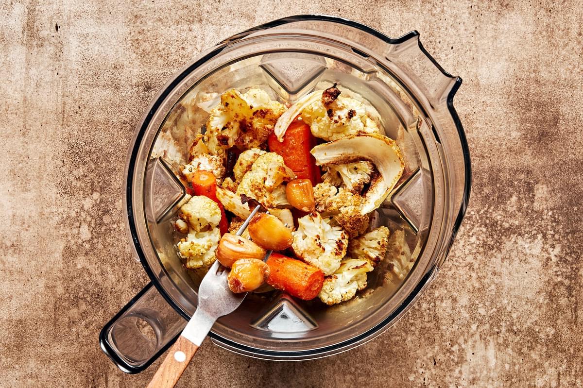 roasted cauliflower, carrots, onion and garlic in a blender