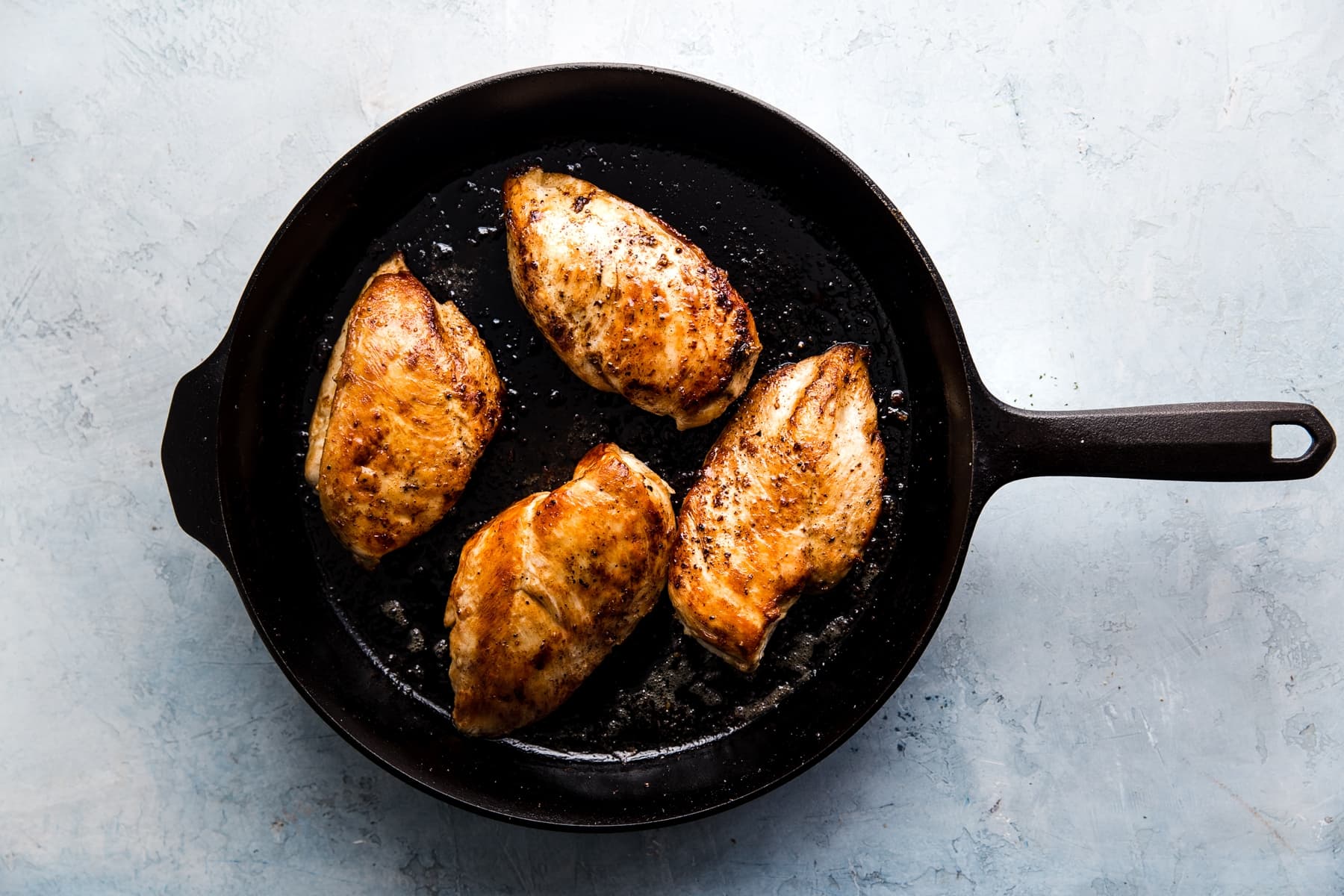 4 chicken breast browned in a large cast iron skillet