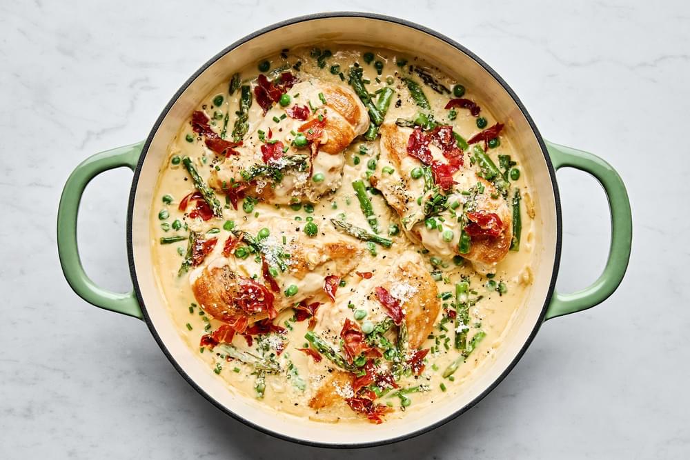 Creamy Chicken skillet with Asparagus & Peas topped with prosciutto, chives, Parmesan & pepper