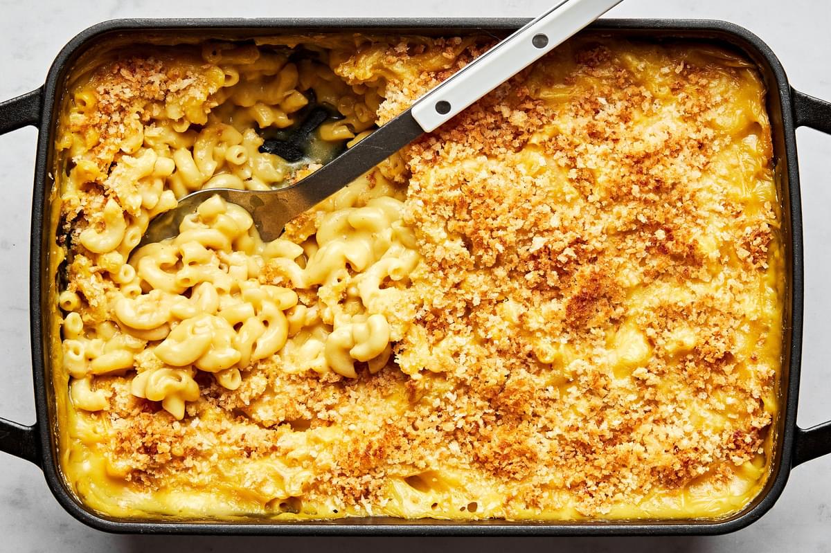 baked dairy free mac and cheese topped with panko bread crumbs in a 9x13 baking dish