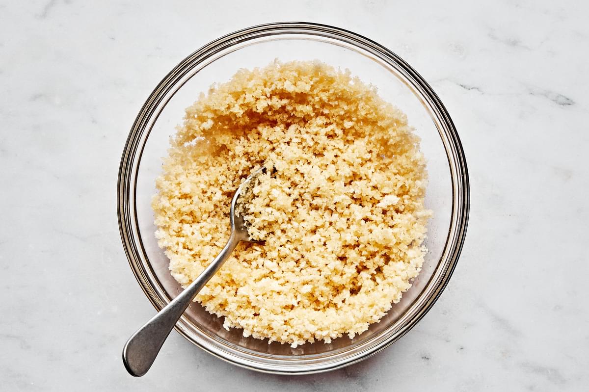 panko crumbs and melted vegan butter being stirred together in a small bowl