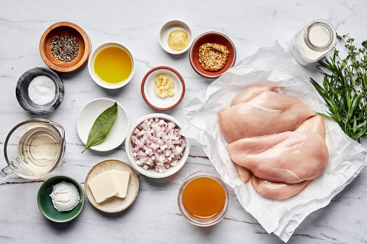 chicken breast, butter, olive oil, spices, cream, white wine, dijon, and chicken stock in prep bowls to make dijon chicken