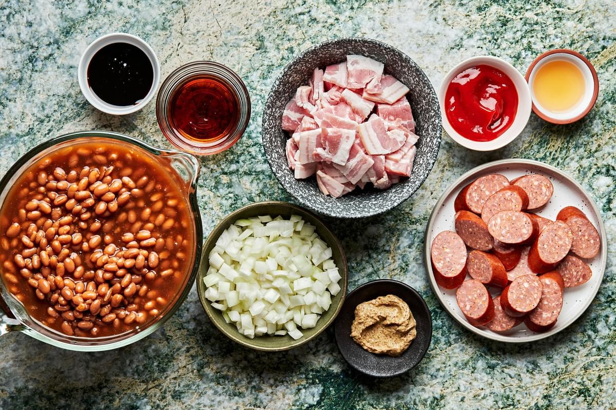 canned baked beans, bacon, sausage, onion, brown mustard, molasses, maple syrup , ketchup & Apple cider vinegar in prep bowls