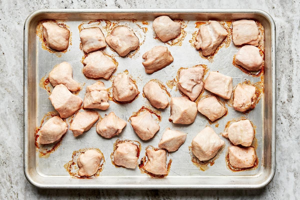bite sized chicken pieces tossed with vegetable oil and salt then baked in the oven on a baking sheet