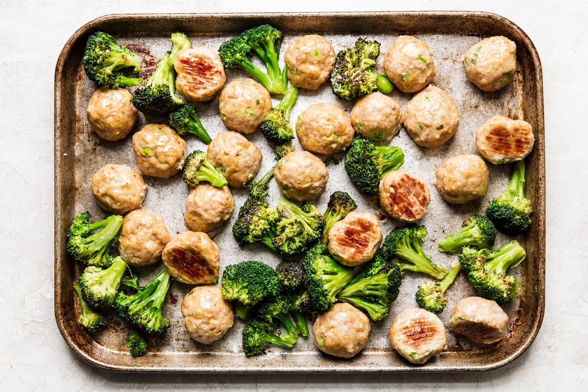 Freezer Teriyaki Chicken Meatballs with broccoli on a baking sheet