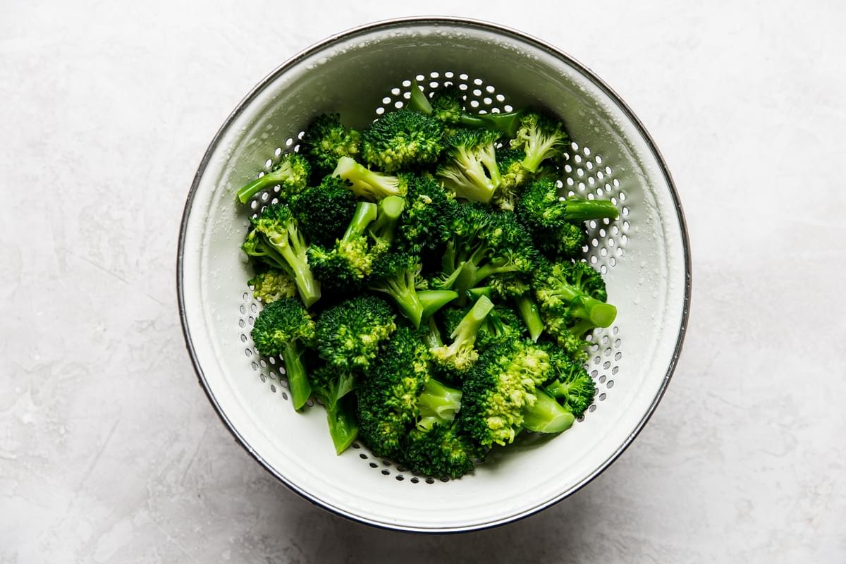 blanched broccoli in a colander