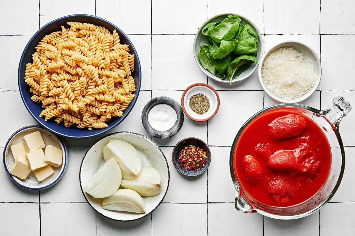 pasta, san marzano tomatoes, salt, italian seasoning, red pepper flakes, basil, onion, butter and parmesan in prep bowls