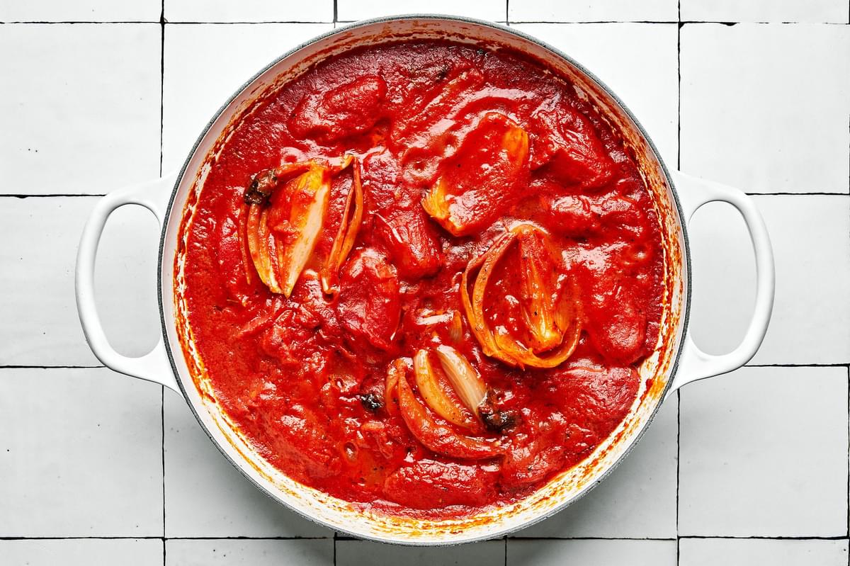 spicy tomato sauce in a pot made with san marzano tomatoes, basil, onion, spices, butter & red pepper flakes