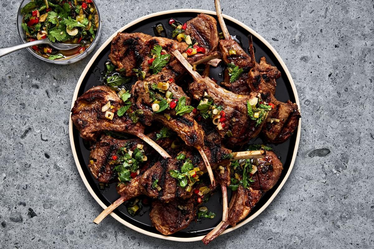 Garam Masala Grilled Lamb Chops with Mint Chutney on a serving platter next to a bowl of extra mint chutney