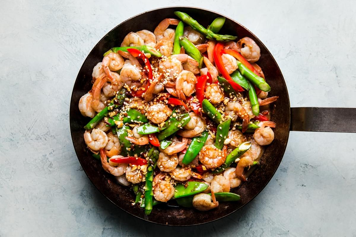 Garlic Shrimp Stir Fry in a pan with asparagus, snow peas, red bell peppers