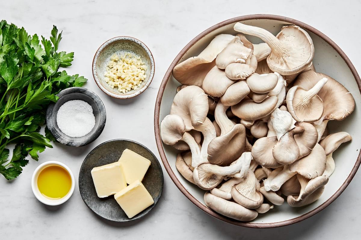 oyster mushrooms, salt, olive oil, butter, garlic and fresh parsley in prep bowls