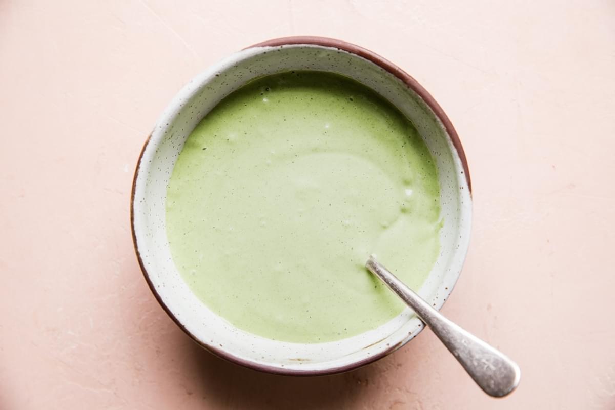 green goddess dressing in a small bowl with a spoon